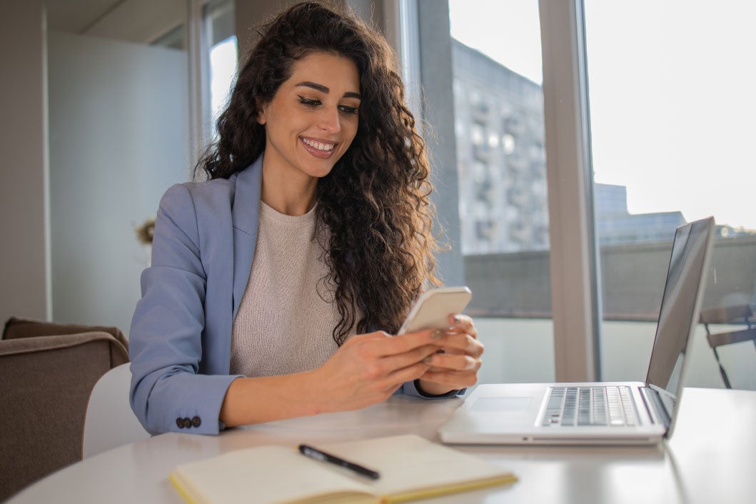 girl smiling with a phone in hands